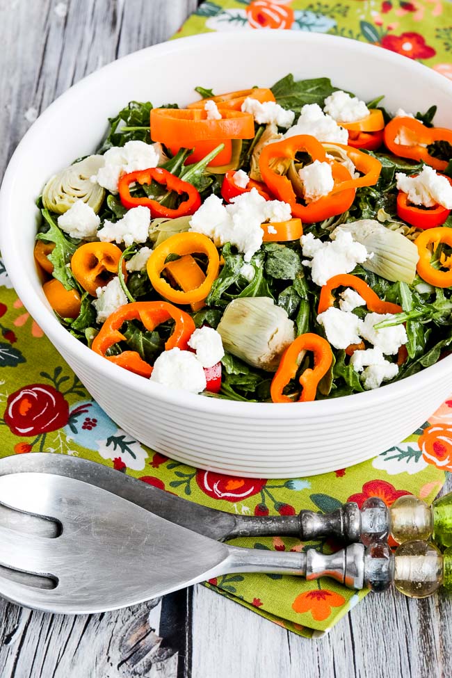 Arugula Salad with Artichokes, Peppers, and Goat Cheese shown in serving bowl with forks