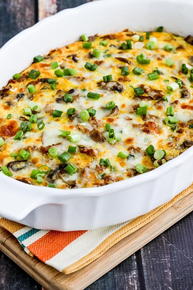Breakfast casserole with Italian Sausage shown in baking dish on cutting board