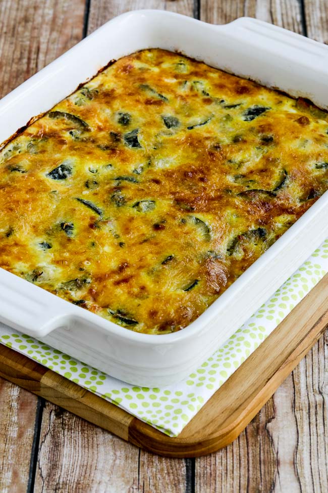 Cheesy Zucchini and Basil Strata in baking dish on cutting board