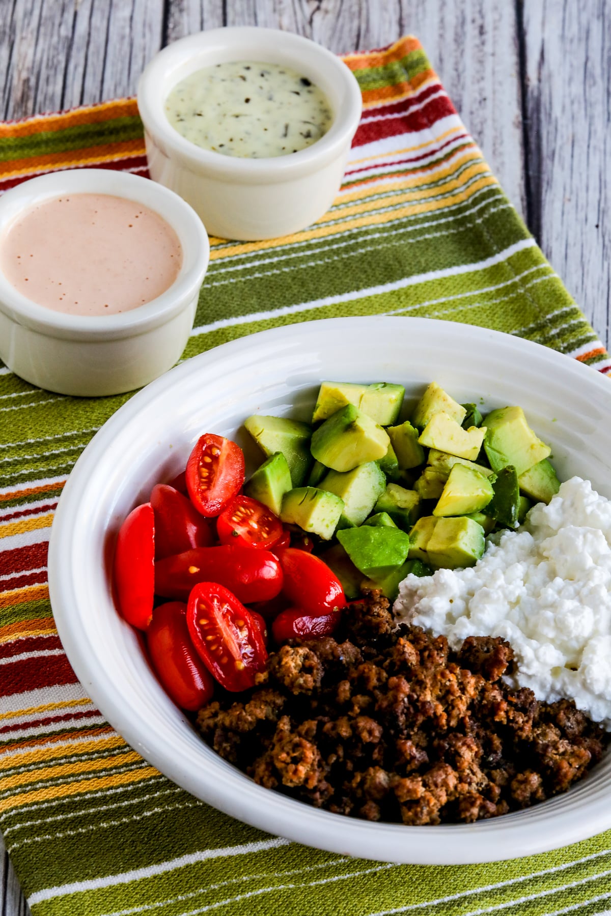 Cottage Cheese Taco Bowl overhead shot with sauces in back.