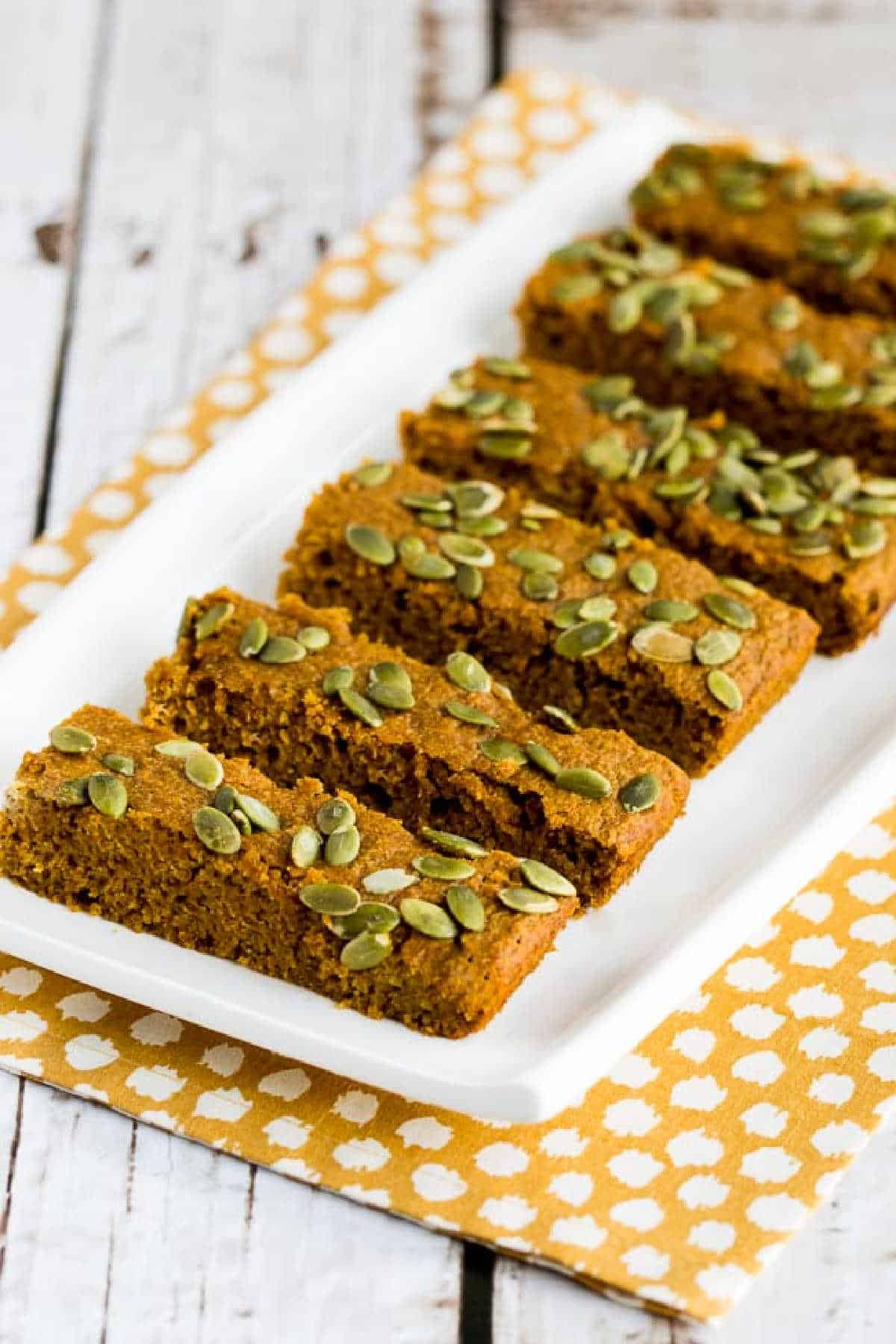 Sugar-Free Pumpkin Bars on white platter and polka-dotting napkin