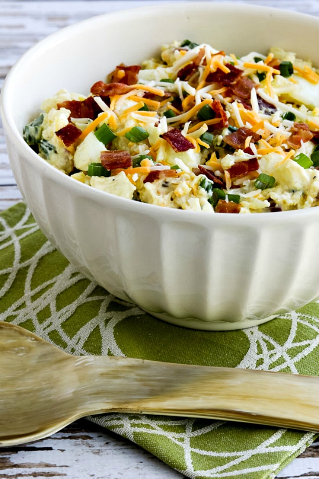Loaded Cauliflower Mock Potato Salad salad in bowl with serving spoon